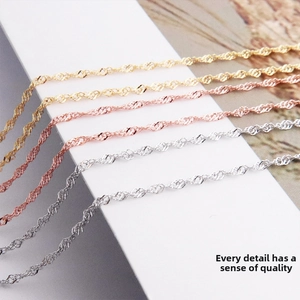 Detailed macro view of S925 sterling silver water wave chains in gold, rose gold and silver