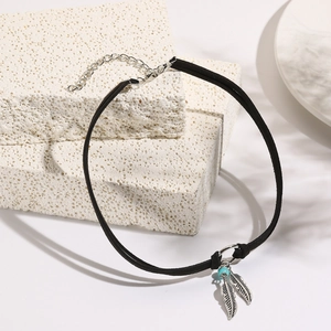 Detail of bohemian black choker with silver feather charms and blue bead on stone