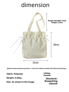 Cream drawstring canvas tote with lace heart bow showing size dimensions and fabric details