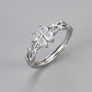 Detailed macro view of S925 silver four-leaf clover ring with vine band and zircon stones