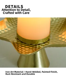 Close-up of golden iron candle holder with hammered texture and welded details