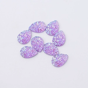 Detailed view of eight purple teardrop-shaped resin crystals with glitter on white base