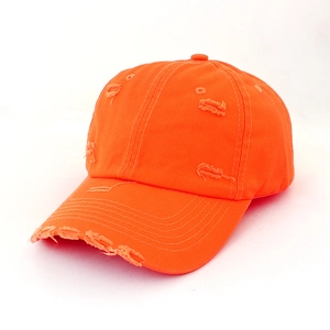 Detailed view of orange distressed baseball cap with vintage frayed brim and worn texture