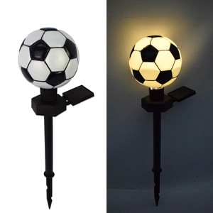 Solar powered football garden stake light showing day and night warm glowing effect