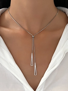Detail of silver geometric Y-necklace with adjustable bead and triangle pendants