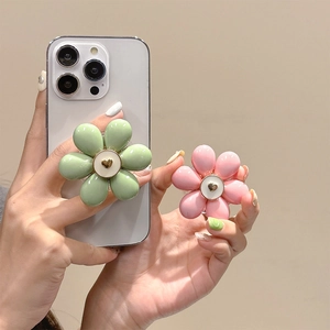 Flower shaped phone socket grip in pink and green with glossy finish heart center