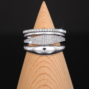 Stackable silver ring set of four with cubic zirconia on a wooden display stand