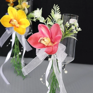 Elegant artificial orchid wine glass floral decor with white organza ribbon and pearls