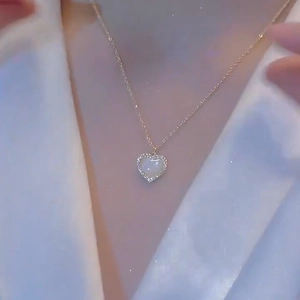 Elegant gold titanium necklace with heart-shaped pearl pendant and zircon accents for women