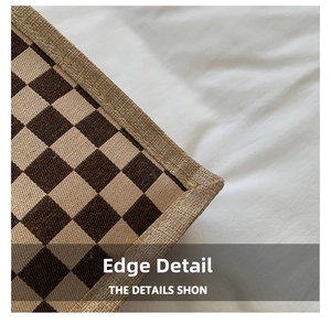 Close-up of the reinforced stitched edge on the brown checkered linen tote bag