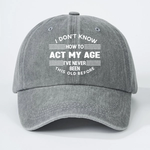 Dark grey washed cotton baseball cap with white I Don't Know How To Act My Age text