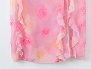 Close-up of pink rose print on lightweight ruffled chiffon fabric with layered details