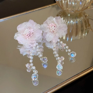 Detail of floral tassel earrings with pink mesh petals, pearls, and iridescent crystals