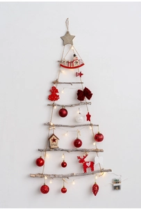 Detail of wooden branch wall-hanging Christmas tree with warm LED lights and ornaments