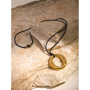 Minimalist 18k gold stainless steel circular pendant on black wax cord necklace