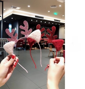 Close-up of sparkling sequin reindeer antlers headbands in festive red and pink colors