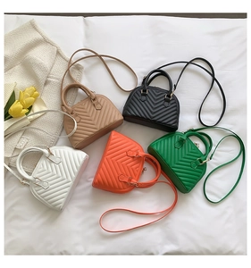Flat lay of mini shell handbags in five colors with V-pattern texture and top handles