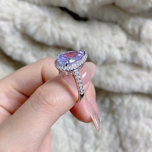 Macro shot of S925 silver pear-cut lavender purple gemstone ring on hand model