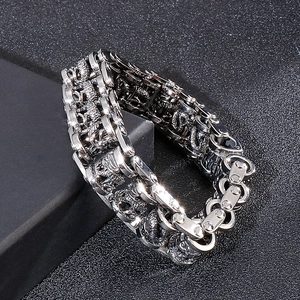 Detailed view of heavy stainless steel motorcycle chain bracelet with dragon relief