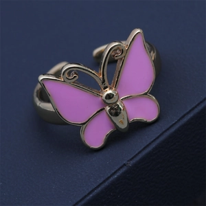 Detailed close-up of golden adjustable butterfly ring with pink oil-dripped wings