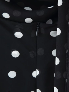Detailed view of white polka dot print dress with a black concealed back zipper