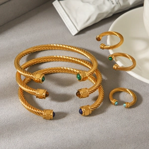 Gold cable twist bangle and ring set with turquoise and malachite stones in luxury scene
