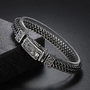 Macro shot of double-row wheat chain bracelet with engraved vintage metal clasp