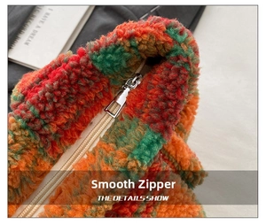 Macro view of a smooth silver zipper on a plush lamb wool tote bag with plaid texture