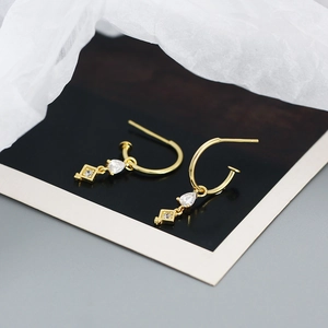Detail of gold-plated S925 silver hoop earrings with zircon drop and square charms