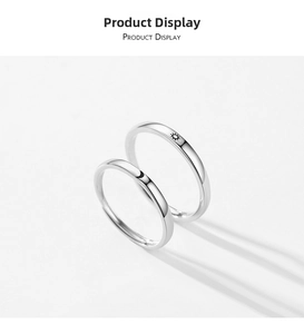Close-up of S925 sterling silver couple rings with engraved sun and moon symbols