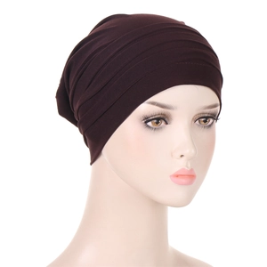 Detailed view of dark brown pleated turban headscarf on a model mannequin head