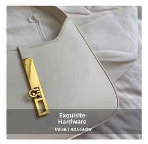 Macro shot of minimalist white leather bag with polished golden geometric metal buckle