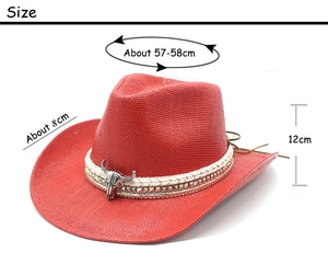 Detail of red cowboy straw hat featuring bull head buckle and dimension markings