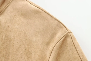 Detailed macro view showing the camel suede texture and stitching on the jacket shoulder