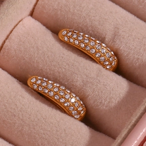 Detailed macro view of gold-plated U-shaped earrings with micro-pave cubic zirconia