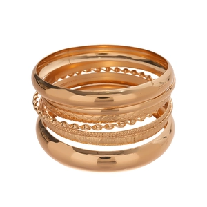 Eight-piece gold plated geometric bangle set with textured and polished metal finishes