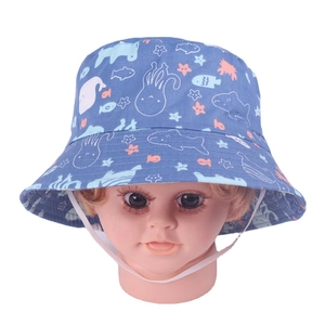 Close-up of blue baby sun hat with colorful sea animal prints and elastic chin strap