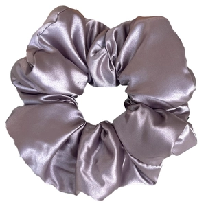 Close-up of oversized mauve satin scrunchie with smooth texture and ruffled design