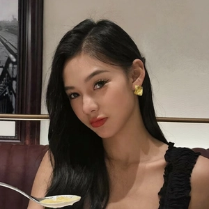 Textured gold-plated diamond shape earrings worn by a model in a luxury vintage setting