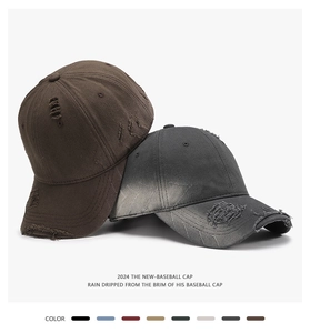 Detail view of washed cotton baseball caps with vintage distressed rip effects and colors