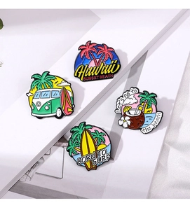 Detail of colorful enamel pins featuring tropical surf themes like palm trees and surfboards