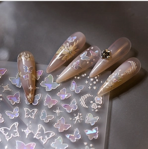 Macro detail of 3D embossed butterfly and flower nail decals with holographic effect