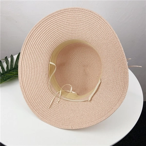 Detail of the pink straw hat interior showing the sweatband and adjustable drawstring strap