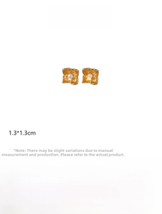 Detail view of golden flower earrings with pearl center and precise dimensions