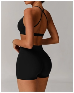 Rear view of black high-stretch sports set with cross-back bra and lifting shorts