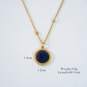 Detailed view of vintage gold necklace with blue gemstone pendant and size measurements