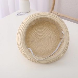 Detail of children's bee straw hat showing adjustable white elastic wind rope and inner band
