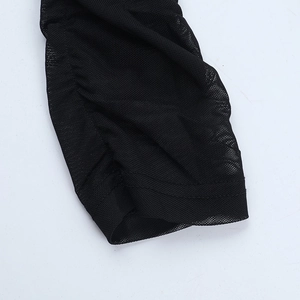 Detailed macro view of black mesh fabric with delicate ruching and reinforced stitching