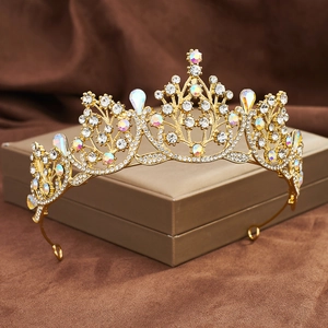 Detail of a golden Baroque crown with teardrop crystals on a brown display case