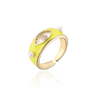 Close-up of evil eye gold ring with yellow enamel, zircon, and pearls details